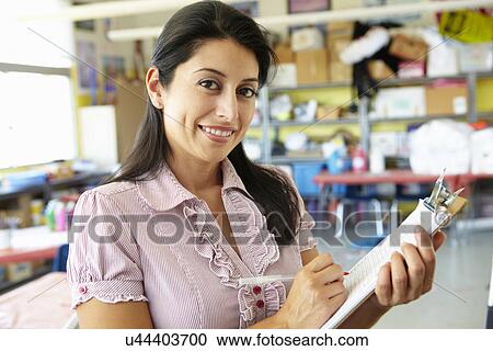 Stock Image - Teacher in classroom. Fotosearch