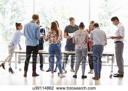 Teacher With College Students Standing By Desks In Classroom View Large Photo Image Stock Image - Teacher With College Students Standing By Desks In Classroom. Fotosearch