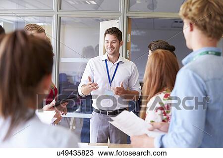 Teacher With College Students Standing By Desks In Classroom View Large Photo Image Stock Image - Teacher With College Students Standing By Desks In Classroom. Fotosearch