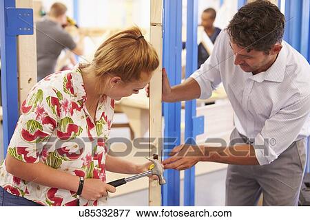 Teacher With Student In Carpentry Class Fitting Door Lock View Large Photo Image Stock Photo - Teacher With Student In Carpentry Class Fitting Door Lock. Fotosearch