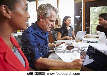 Team Of Architects Working At Desks In Office View Large Photo Image Stock Image - Team Of Architects Working At Desks In Office. Fotosearch