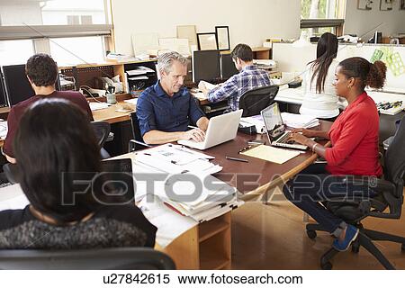 Team Of Architects Working At Desks In Office View Large Photo Image Stock Photography - Team Of Architects Working At Desks In Office. Fotosearch