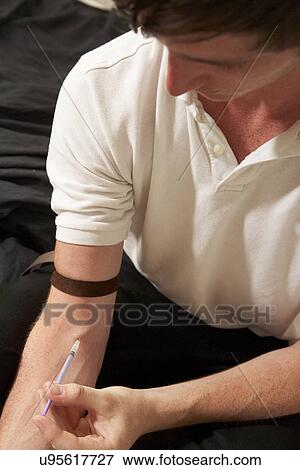 Stock Photo - Teenage boy injecting drugs. Fotosearch