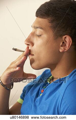 Stock Photo - Teenage boy smoking. Fotosearch