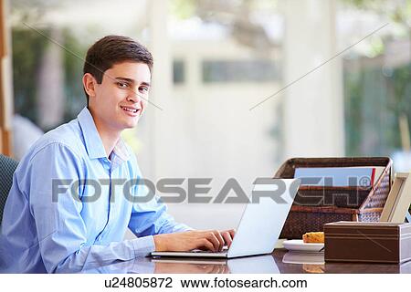 Teenage Boy Using Laptop On Desk At Home View Large Photo Image Stock Image - Teenage Boy Using Laptop On Desk At Home. Fotosearch