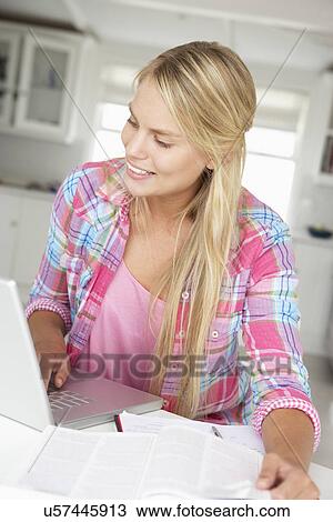 Teenage girl doing homework with laptop View Large Photo Image Stock Image - Teenage girl doing homework with laptop. Fotosearch
