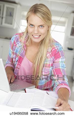 Teenage girl doing homework with laptop View Large Photo Image Stock Photo - Teenage girl doing homework with laptop. Fotosearch