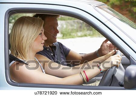 Stock Image - Teenage girl learning to drive. Fotosearch