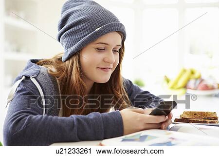 Teenage Girl Sending Text Message Whilst Studying View Large Photo Image Stock Image - Teenage Girl Sending Text Message Whilst Studying. Fotosearch