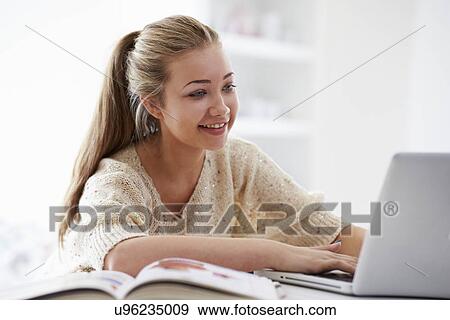 Teenage Girl Studying On Laptop At Home View Large Photo Image Stock Photo - Teenage Girl Studying On Laptop At Home. Fotosearch
