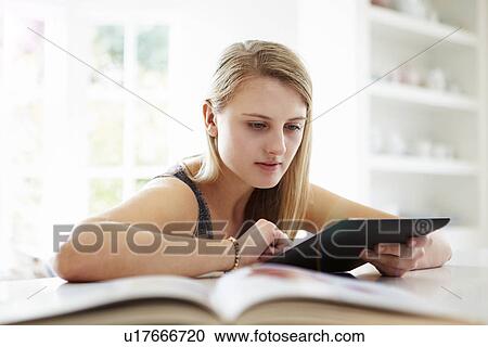 Teenage Girl Studying Using Digital Tablet At Home View Large Photo Image Stock Image - Teenage Girl Studying Using Digital Tablet At Home. Fotosearch