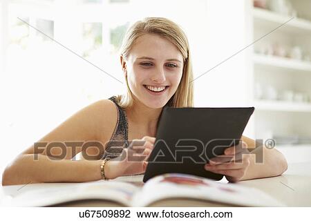 Teenage Girl Studying Using Digital Tablet At Home View Large Photo Image Stock Image - Teenage Girl Studying Using Digital Tablet At Home. Fotosearch