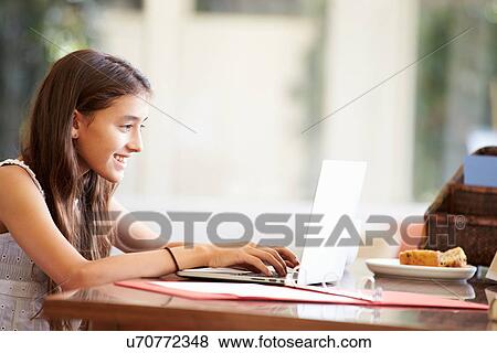 Teenage Girl Using Laptop On Desk At Home View Large Photo Image Stock Photo - Teenage Girl Using Laptop On Desk At Home. Fotosearch