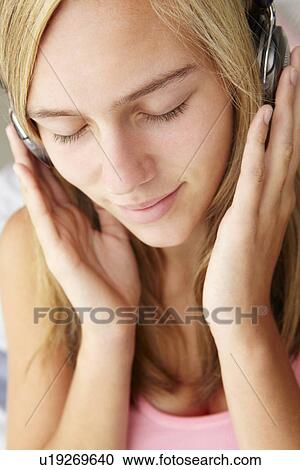 Teenage girl wearing headphones View Large Photo Image Stock Image - Teenage girl wearing headphones. Fotosearch