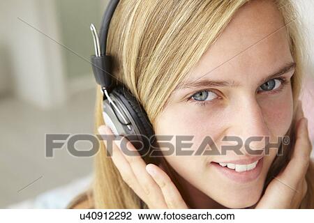 Teenage girl wearing headphones View Large Photo Image Stock Image - Teenage girl wearing headphones. Fotosearch
