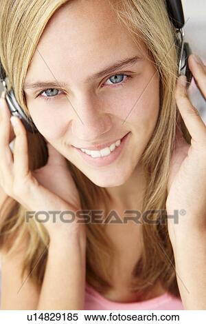 Stock Photography - Teenage girl wearing headphones. Fotosearch