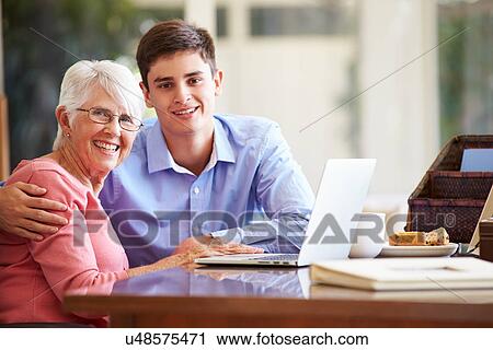 Teenage Grandson Helping Grandmother With Laptop View Large Photo Image Stock Image - Teenage Grandson Helping Grandmother With Laptop. Fotosearch