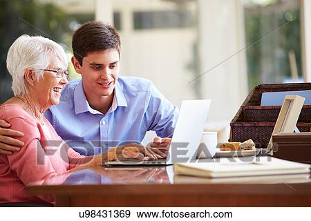 Teenage Grandson Helping Grandmother With Laptop View Large Photo Image Stock Photo - Teenage Grandson Helping Grandmother With Laptop. Fotosearch