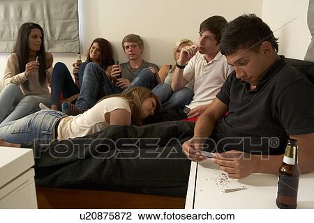 Stock Image - Teenagers drinking and smoking. Fotosearch