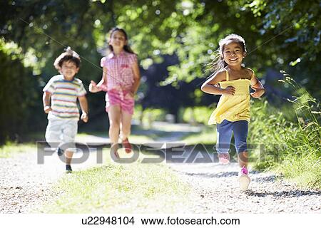 Picture - Three Asian Children Enjoying Walk In Countryside. Fotosearch