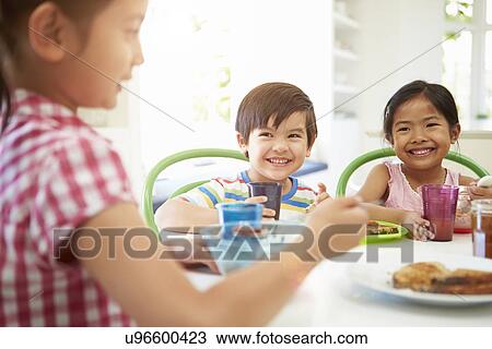 Three Asian Children Having Breakfast Together In Kitchen View Large Photo Image Stock Image - Three Asian Children Having Breakfast Together In Kitchen. Fotosearch