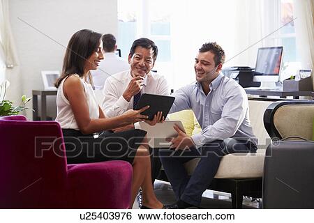 Three Businesspeople Having Meeting In Hotel Lobby View Large Photo Image Stock Photograph - Three Businesspeople Having Meeting In Hotel Lobby. Fotosearch