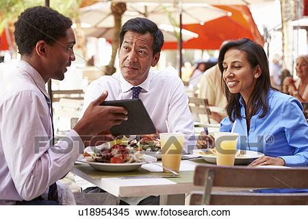 Three Businesspeople Having Meeting In Outdoor Restaurant View Large Photo Image Stock Photography - Three Businesspeople Having Meeting In Outdoor Restaurant. Fotosearch