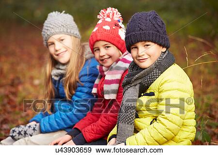 Three Children On Walk Through Winter Woodland View Large Photo Image Stock Photo - Three Children On Walk Through Winter Woodland. Fotosearch
