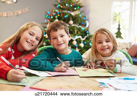 Picture - Three Children Writing Letters To Santa Together. Fotosearch