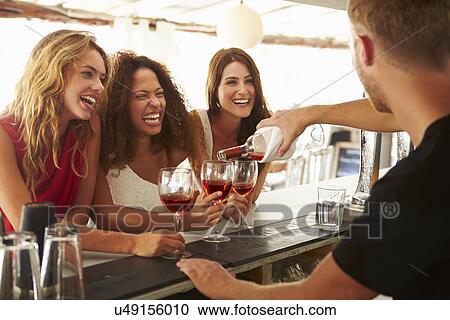 Three Female Friends Enjoying Drink At Outdoor Bar View Large Photo Image Stock Image - Three Female Friends Enjoying Drink At Outdoor Bar. Fotosearch
