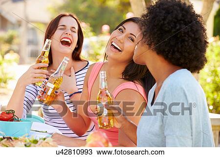 Three Female Friends Enjoying Meal At Outdoor Party View Large Photo Image Stock Image - Three Female Friends Enjoying Meal At Outdoor Party. Fotosearch