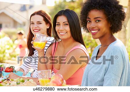 Three Female Friends Enjoying Meal At Outdoor Party View Large Photo Image Stock Image - Three Female Friends Enjoying Meal At Outdoor Party. Fotosearch