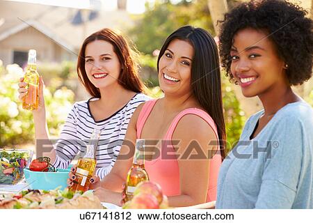 Three Female Friends Enjoying Meal At Outdoor Party View Large Photo Image Stock Image - Three Female Friends Enjoying Meal At Outdoor Party. Fotosearch