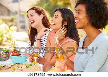 Three Female Friends Enjoying Meal At Outdoor Party View Large Photo Image Stock Photography - Three Female Friends Enjoying Meal At Outdoor Party. Fotosearch