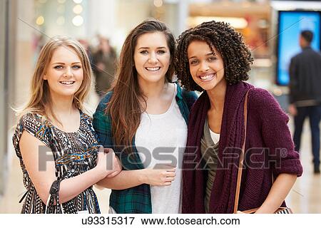 Three Female Friends Shopping In Mall Together View Large Photo Image Stock Photo - Three Female Friends Shopping In Mall Together. Fotosearch