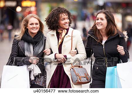 Stock Photo - Three Female Friends Shopping Outdoors Together. Fotosearch