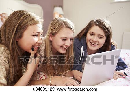 Three Teenage Girls Using Laptop In Bedroom View Large Photo Image Stock Photo - Three Teenage Girls Using Laptop In Bedroom. Fotosearch