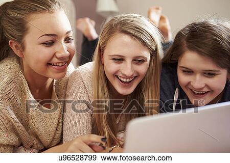 Three Teenage Girls Using Laptop In Bedroom View Large Photo Image Stock Photo - Three Teenage Girls Using Laptop In Bedroom. Fotosearch