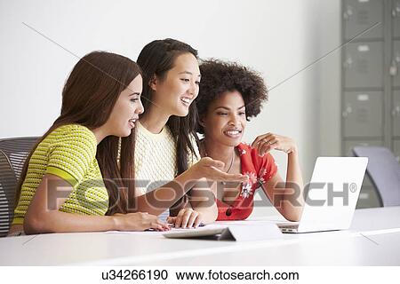 Stock Image - Three Women Working Together In Design Studio. Fotosearch
