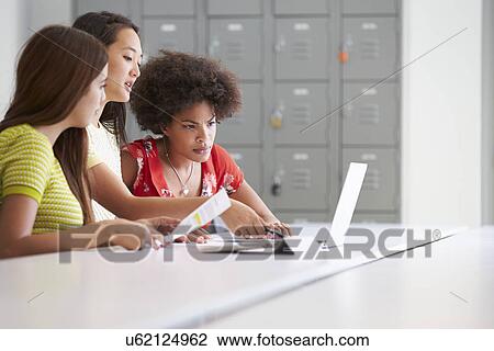 Stock Image - Three Women Working Together In Design Studio. Fotosearch