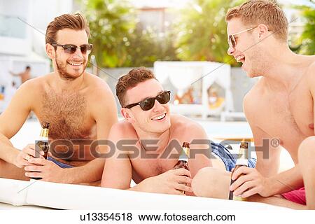Three Young Male Friends On Holiday By Pool Together View Large Photo Image Stock Photo - Three Young Male Friends On Holiday By Pool Together. Fotosearch