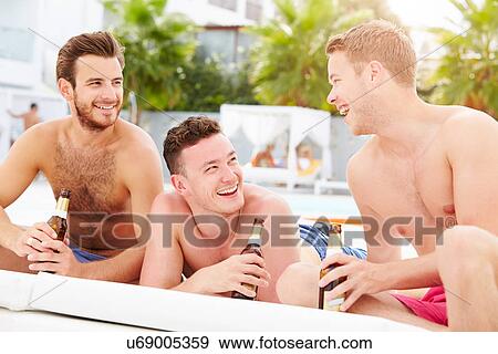 Three Young Male Friends On Holiday By Pool Together View Large Photo Image Stock Photo - Three Young Male Friends On Holiday By Pool Together. Fotosearch