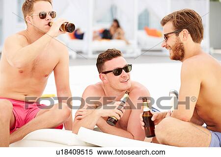 Stock Photography - Three Young Male Friends On Holiday By Pool Together. Fotosearch