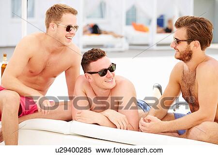 Three Young Male Friends On Holiday By Pool Together View Large Photo Image Stock Photography - Three Young Male Friends On Holiday By Pool Together. Fotosearch