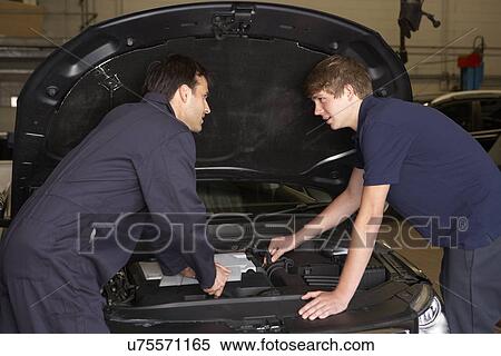 Stock Photography - Trainee mechanic at work. Fotosearch