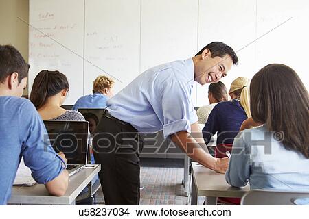 Tutor Helping High School Students In Class View Large Photo Image Picture - Tutor Helping High School Students In Class. Fotosearch