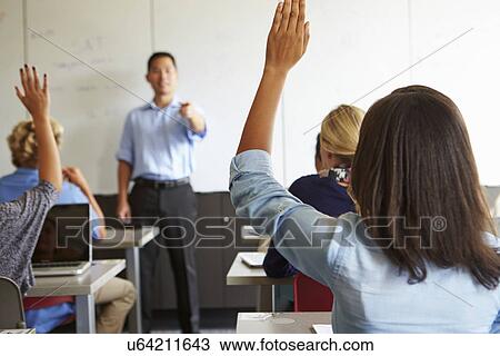 Stock Image - Tutor With High School Students In Class Using Laptops. Fotosearch