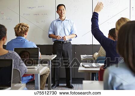 Tutor With High School Students In Class Using Laptops View Large Photo Image Stock Image - Tutor With High School Students In Class Using Laptops. Fotosearch