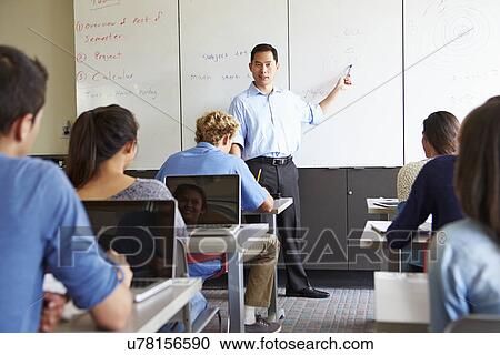 Tutor With High School Students In Class Using Laptops View Large Photo Image Stock Image - Tutor With High School Students In Class Using Laptops. Fotosearch