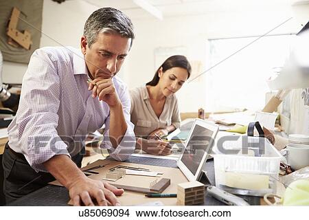 Picture - Two Architects Making Models In Office Using Digital Tablet. Fotosearch